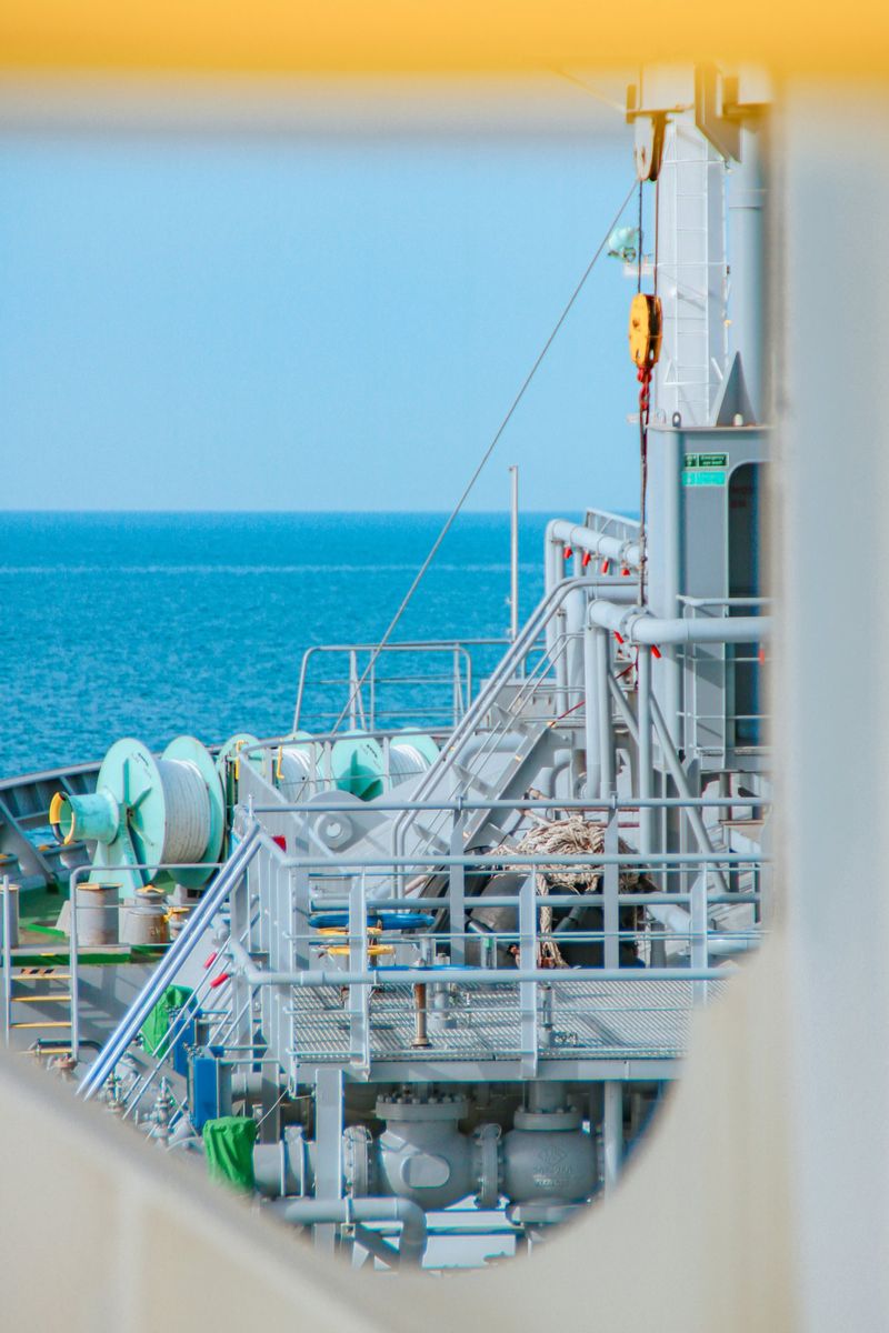 Pipework and mooring winches on a tanker deck, looking out to sea